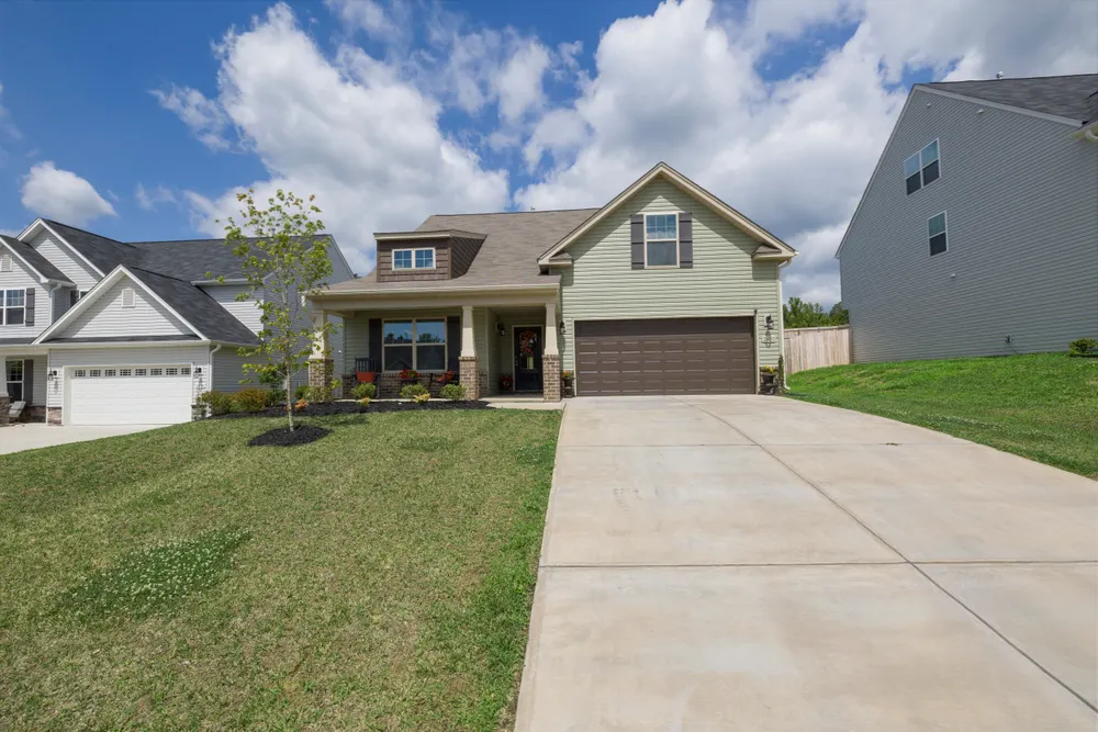 Modern suburban detached house with a driveway and attached garage