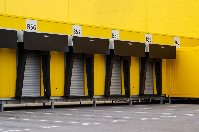 Row of industrial loading dock bays with closed doors