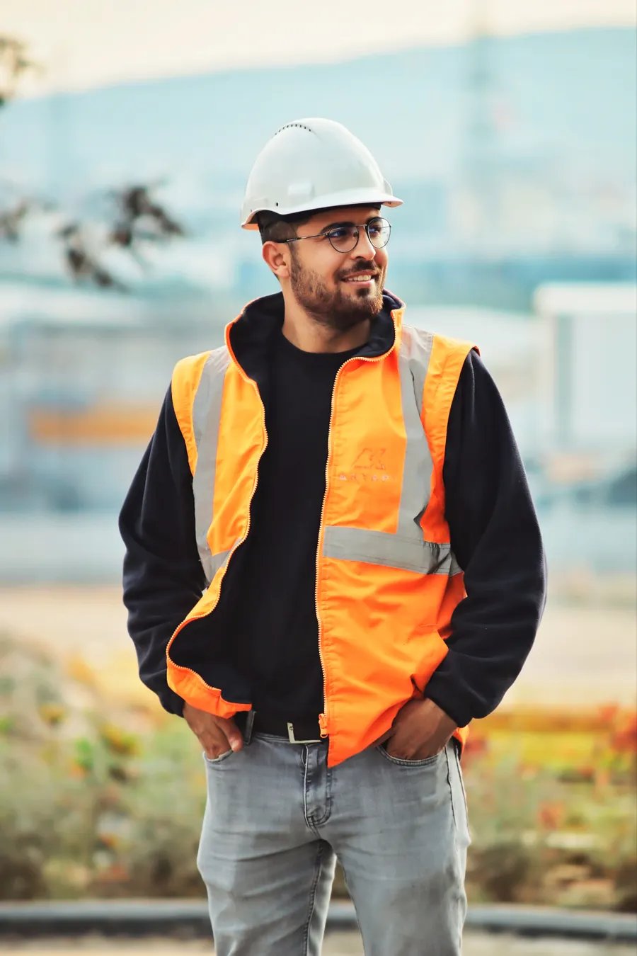 Doors, Inc. technician in a hard hat and high-visibility vest on site